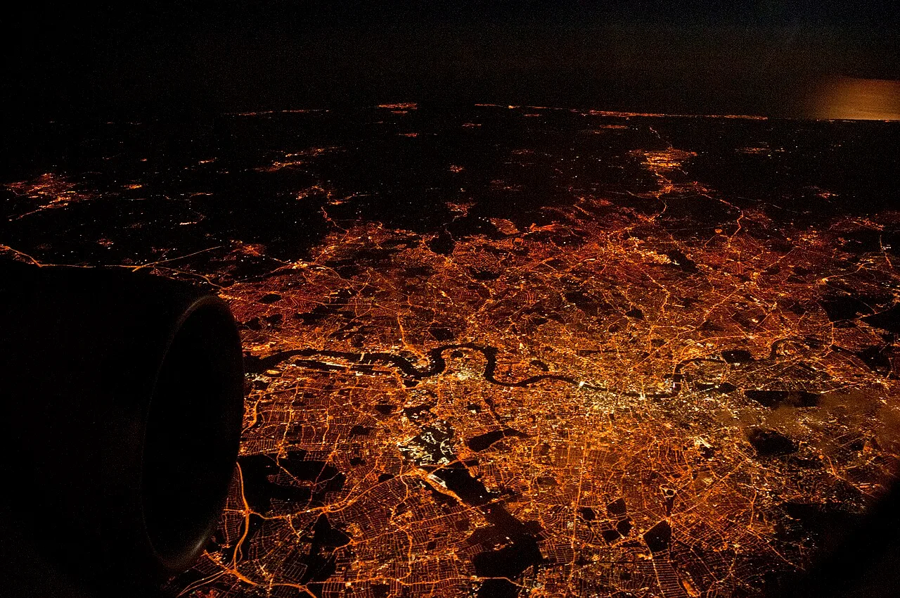 Greater London and the south coast of England lit up at night, seen from the air.